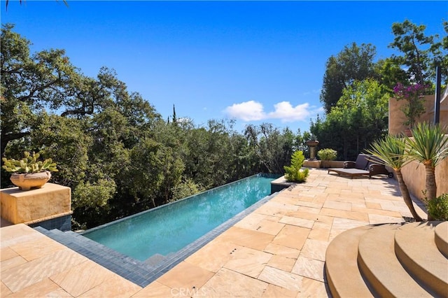 view of pool featuring a patio and an infinity pool