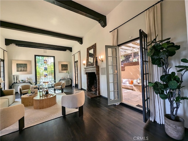 living area featuring french doors, beam ceiling, a fireplace with raised hearth, and dark wood-style flooring