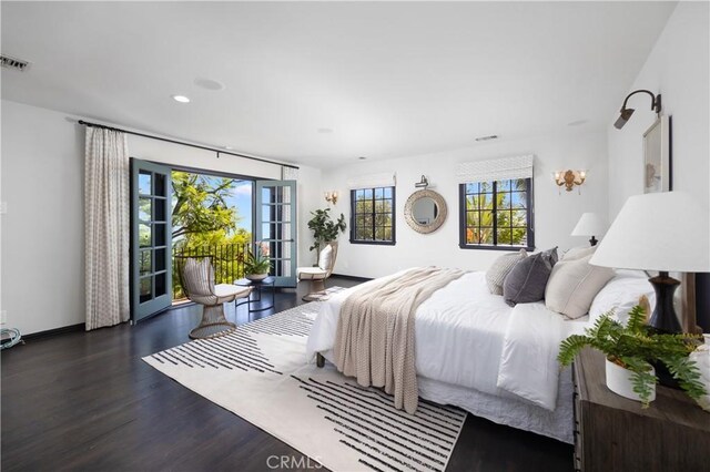 bedroom with dark wood-type flooring and access to exterior