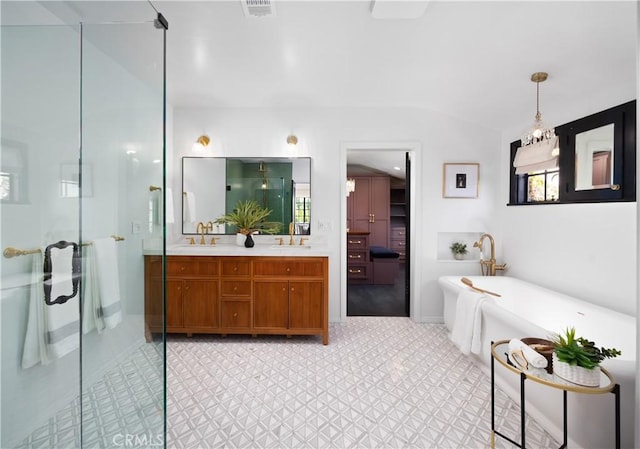 bathroom featuring a freestanding tub, visible vents, a sink, a shower stall, and double vanity