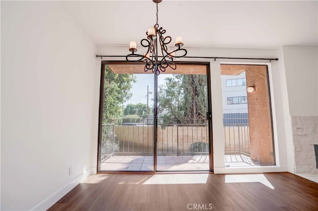 unfurnished dining area featuring hardwood / wood-style flooring and a healthy amount of sunlight