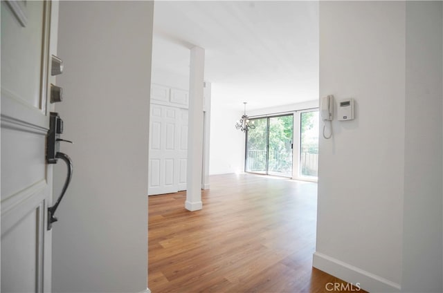 corridor with light hardwood / wood-style flooring