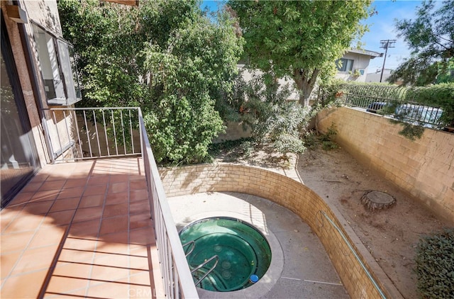 view of swimming pool with an in ground hot tub