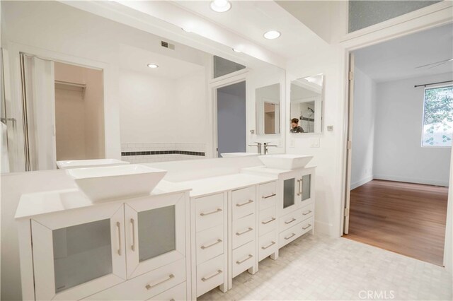 bathroom with ceiling fan, vanity, and hardwood / wood-style flooring