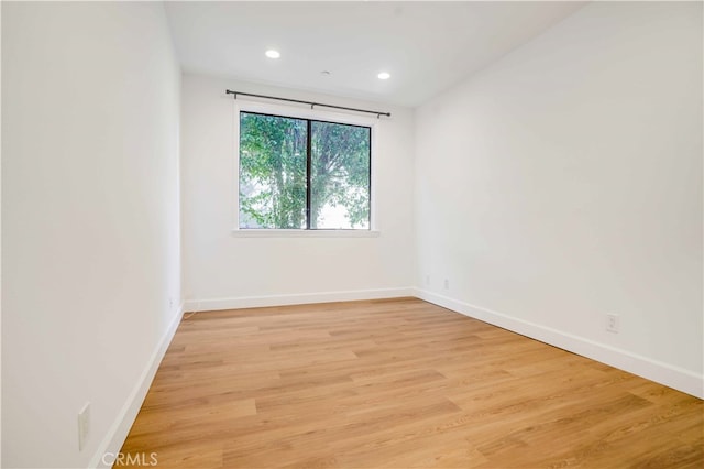 spare room with light hardwood / wood-style flooring