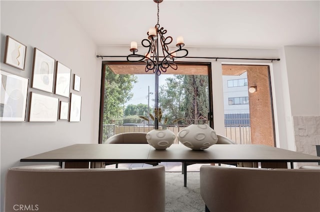 dining room featuring a wealth of natural light and an inviting chandelier