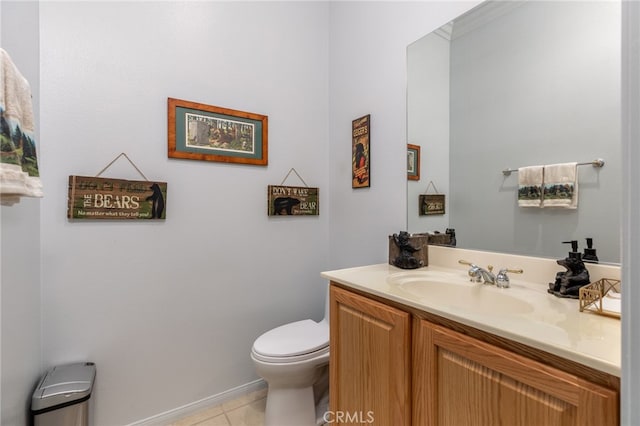 bathroom with tile patterned flooring, vanity, and toilet