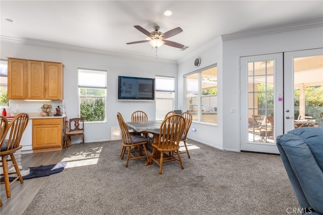 dining space with french doors, ceiling fan, ornamental molding, and a healthy amount of sunlight