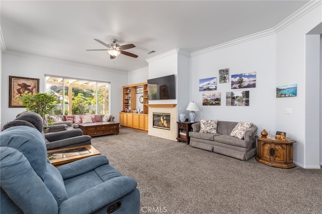 carpeted living room featuring crown molding and ceiling fan