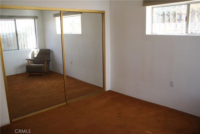 unfurnished bedroom with carpet floors and a closet