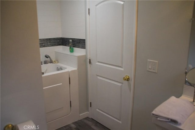 bathroom featuring hardwood / wood-style floors and a washtub