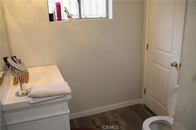 bathroom with vanity, wood-type flooring, and toilet