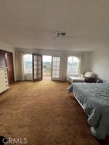 carpeted bedroom featuring access to exterior