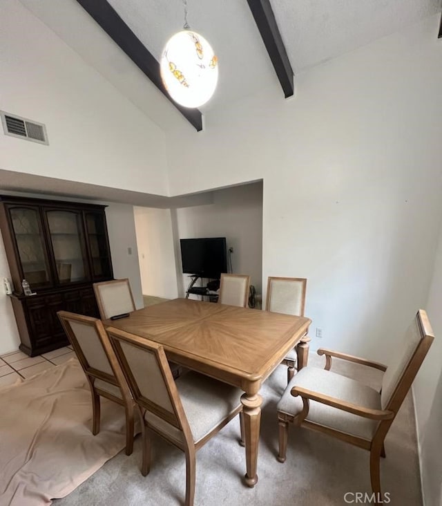 dining area with high vaulted ceiling, light colored carpet, and beamed ceiling