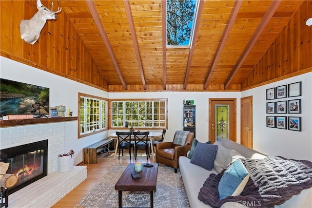 living room with beam ceiling, wooden ceiling, high vaulted ceiling, wood-type flooring, and a fireplace