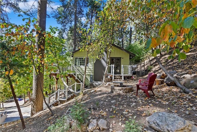 back of house with a wooden deck and french doors