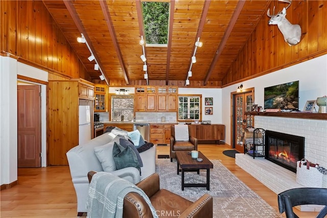 living room featuring high vaulted ceiling, light hardwood / wood-style flooring, and wood ceiling