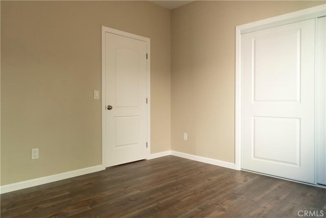 spare room with dark hardwood / wood-style floors