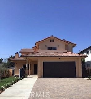 mediterranean / spanish home with a garage