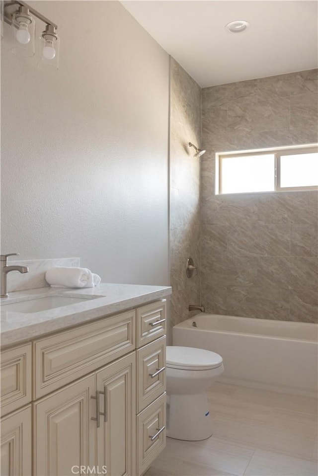 full bathroom with tile patterned floors, vanity, toilet, and tiled shower / bath