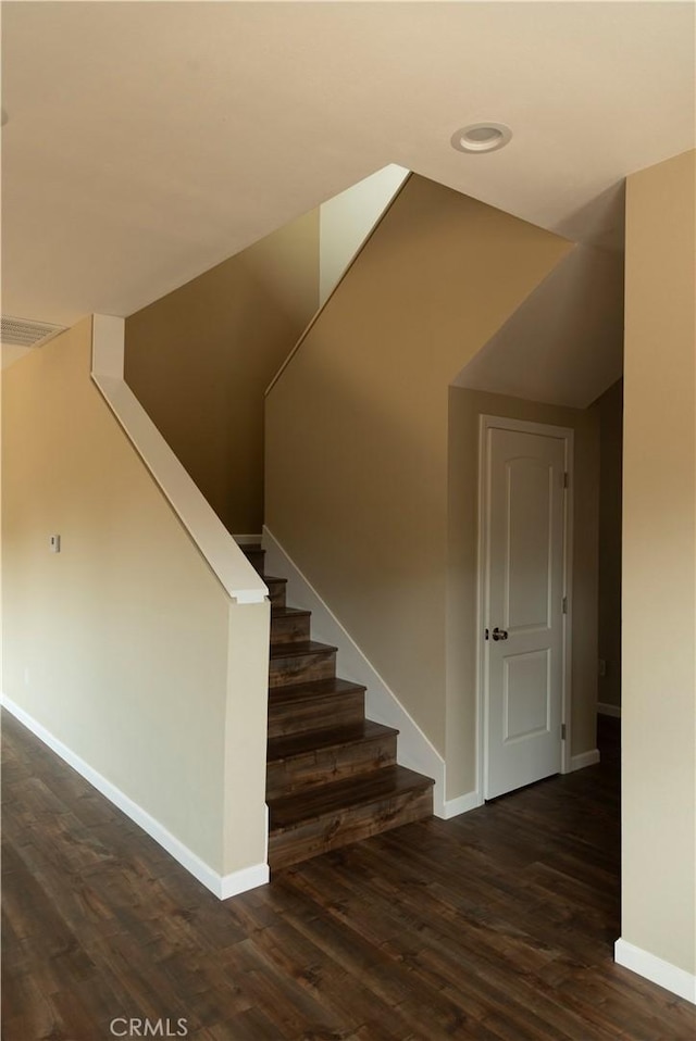 stairs featuring hardwood / wood-style flooring