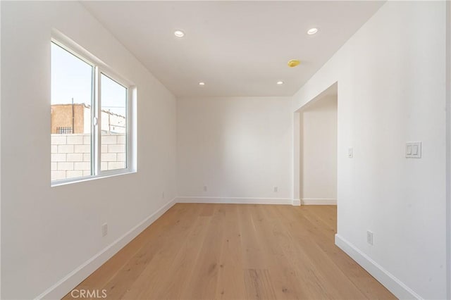 unfurnished room with light wood-type flooring