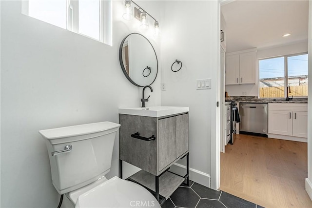 bathroom with hardwood / wood-style floors, vanity, and toilet