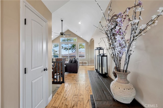 hallway with vaulted ceiling and wood-type flooring