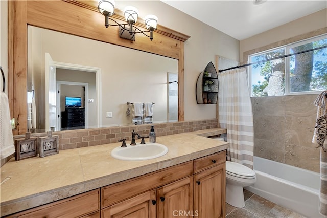 full bathroom featuring vanity, tasteful backsplash, shower / bath combination with curtain, tile patterned floors, and toilet