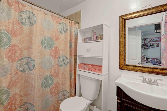 bathroom with toilet, curtained shower, and vanity