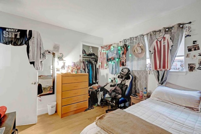 bedroom featuring a closet and light wood-type flooring