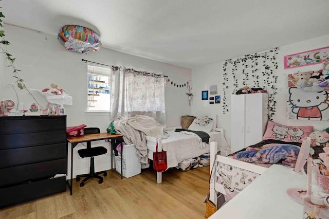 bedroom with hardwood / wood-style flooring