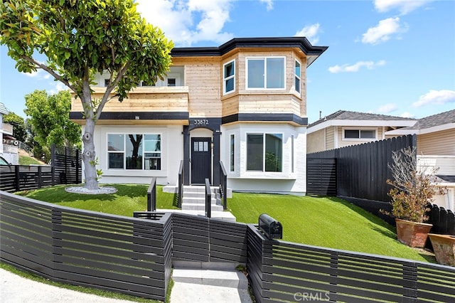 modern home featuring a front yard