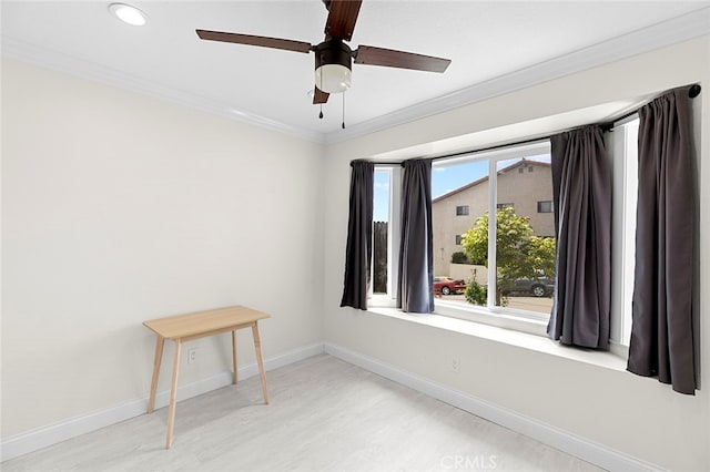 empty room with crown molding, hardwood / wood-style flooring, and ceiling fan