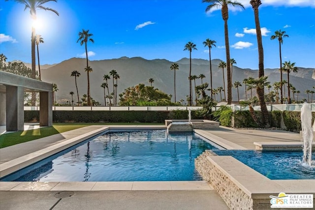 view of swimming pool featuring a patio area, a mountain view, and pool water feature