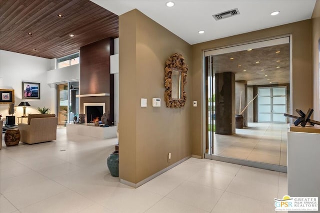 hall with light tile patterned floors