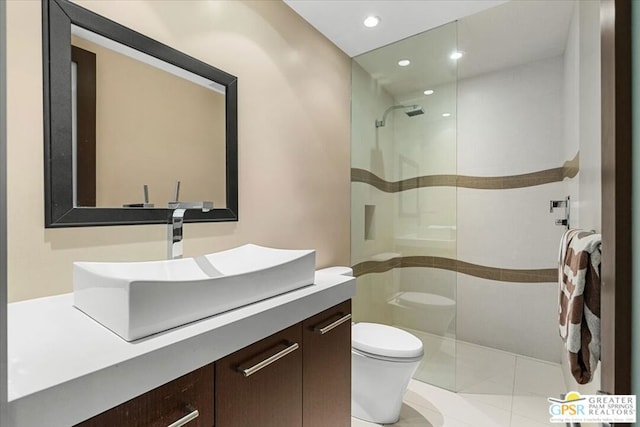 bathroom with a shower, tile patterned floors, vanity, and toilet