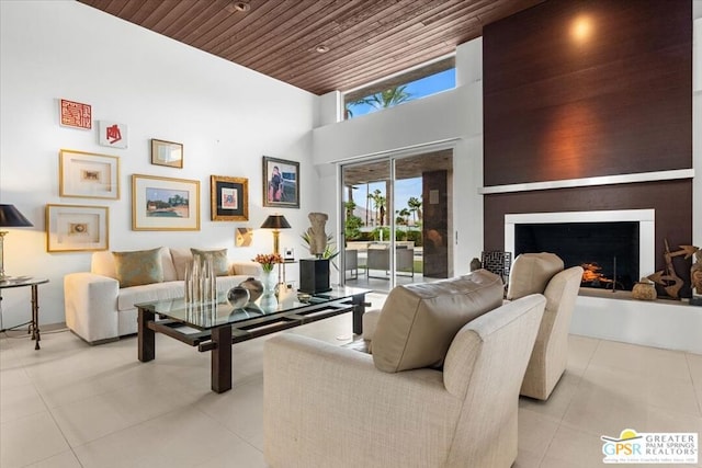 living room featuring a towering ceiling and wood ceiling