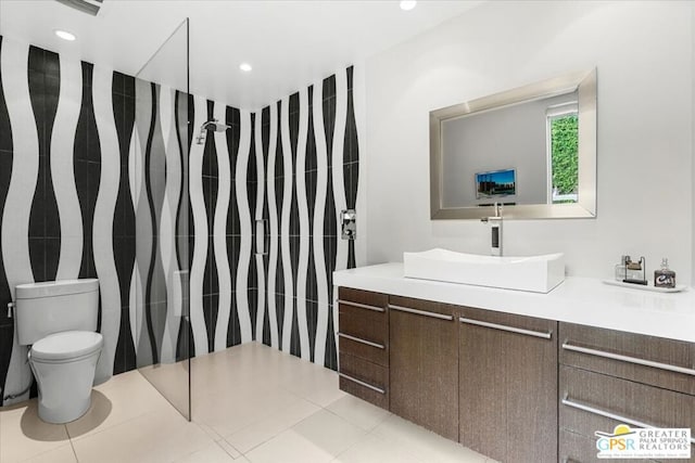 bathroom with vanity, toilet, and tile patterned floors