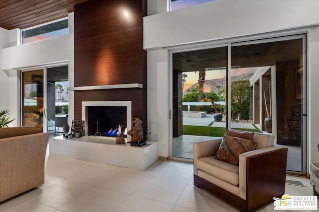 living room with a large fireplace and a wealth of natural light