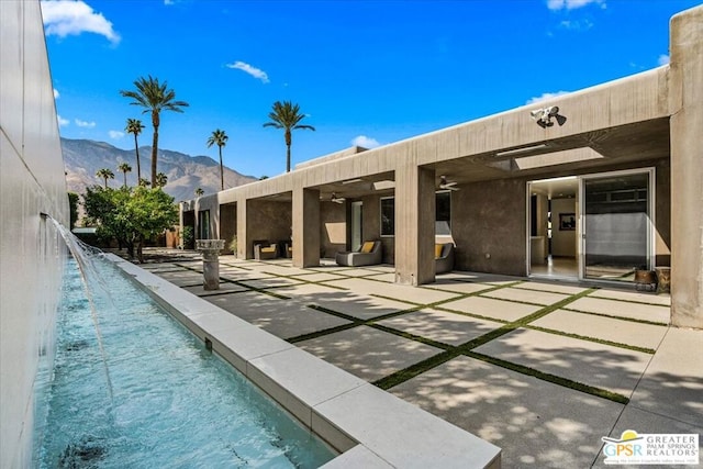 view of swimming pool featuring a mountain view, a patio area, and pool water feature