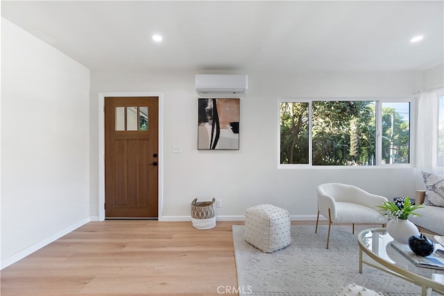 entryway with light hardwood / wood-style flooring and a wall mounted air conditioner