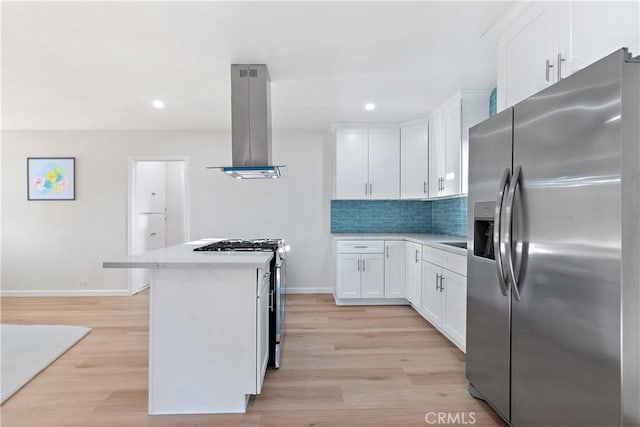 kitchen with white cabinets, stainless steel fridge with ice dispenser, light hardwood / wood-style flooring, and wall chimney range hood