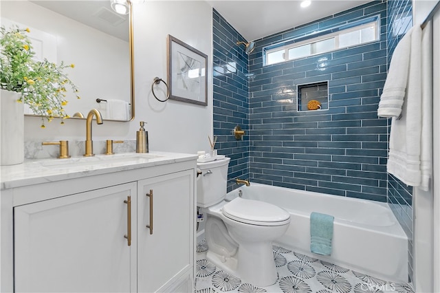 full bathroom featuring tile patterned flooring, vanity, toilet, and tiled shower / bath combo