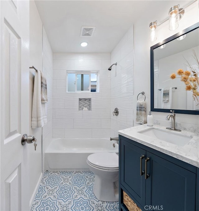 full bathroom featuring vanity, toilet, and tiled shower / bath