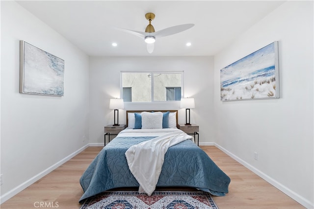 bedroom with ceiling fan and light hardwood / wood-style flooring