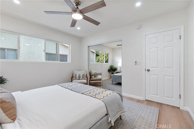 bedroom featuring ceiling fan, a closet, and light hardwood / wood-style floors