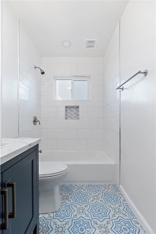 bathroom featuring tile patterned floors, vanity, and toilet