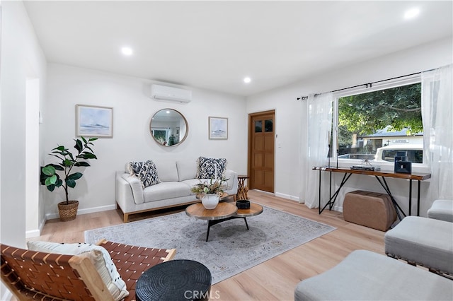 living room with light hardwood / wood-style floors and a wall mounted AC