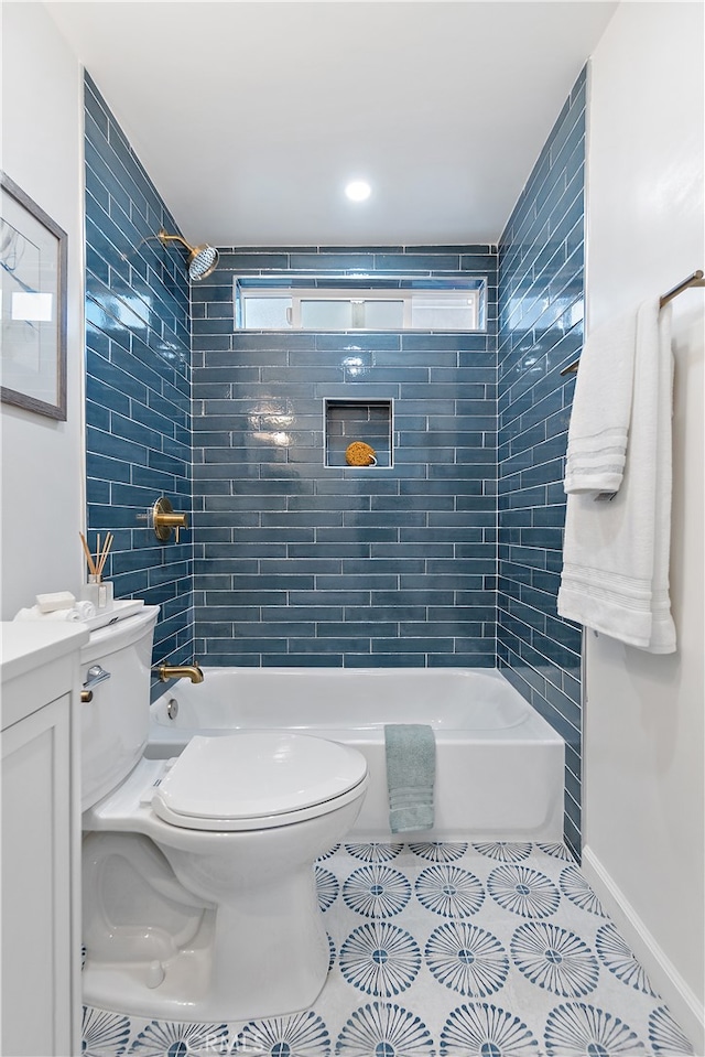 full bathroom featuring tile patterned floors, vanity, toilet, and tiled shower / bath